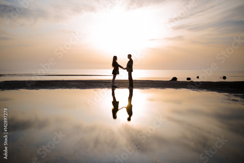  Loving couple silhouetted at sunset
