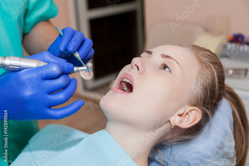 Woman at the dentist's chair during a dental procedure. 