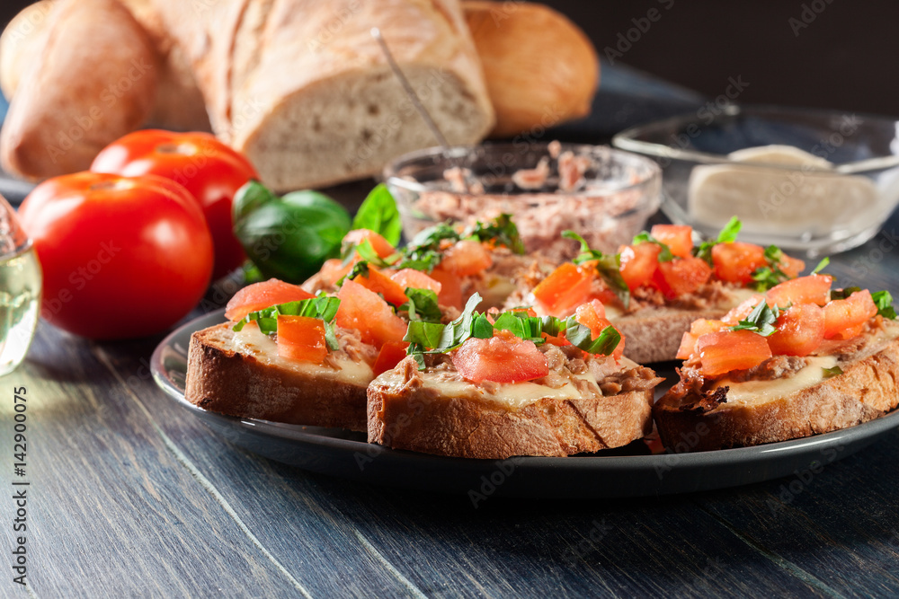 Appetizer bruschetta with tuna, mozarella cheese and tomatoes