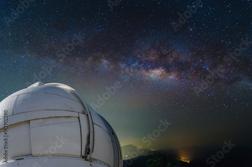 observatory with milky way galaxy, long exposure photograph, with grain.Image contain certain grain or noise and soft focus. color tone effect, astronomy concept. photo