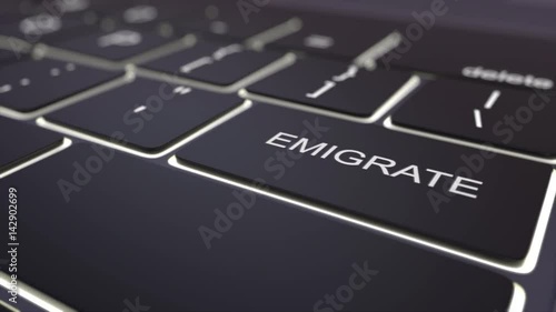Dolly shot of black luminous computer keyboard and emigrate key. Conceptual 4K clip