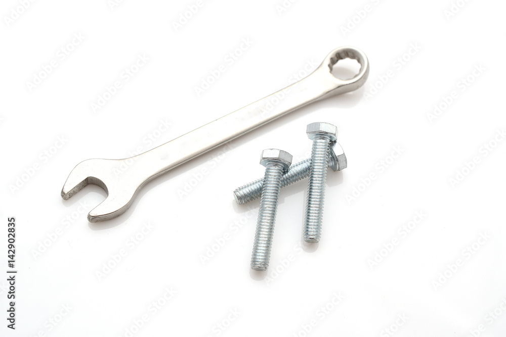 Three bolts And the key isolated on white background. Industry abstraction. A photo for your store. Three bolts And the key isolated on white background. Industry abstraction. A photo for your store.