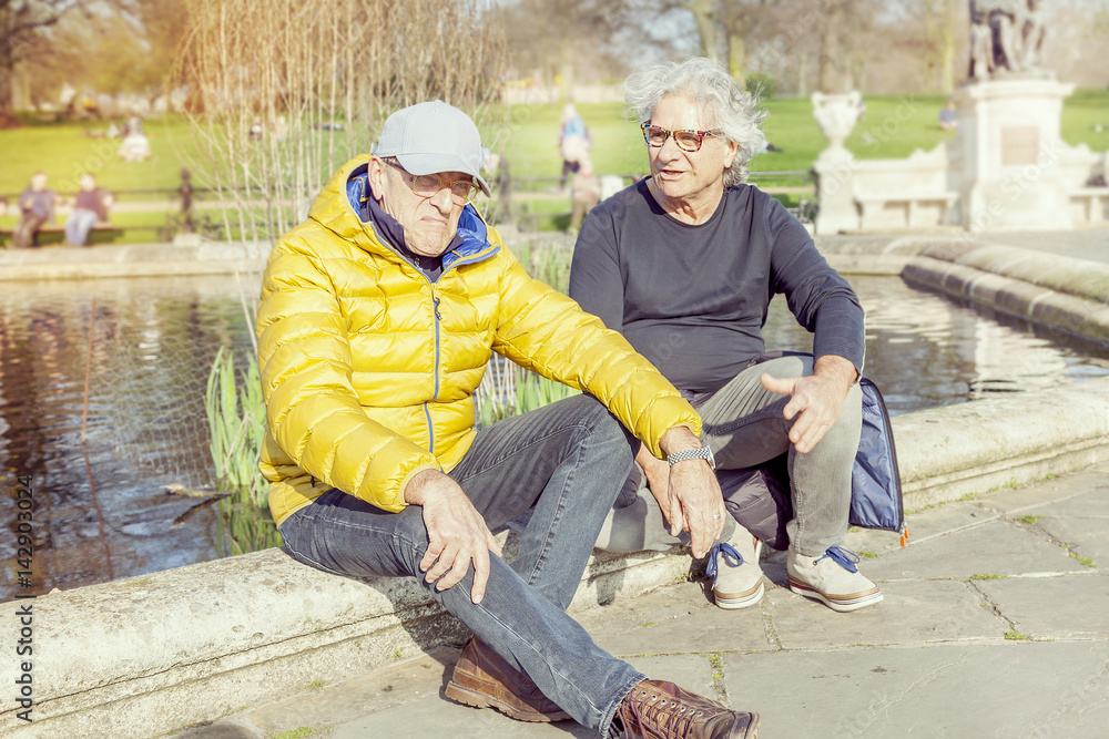 mature men friends enjoying vacation in a modern city mature men friends enjoying vacation in a modern city