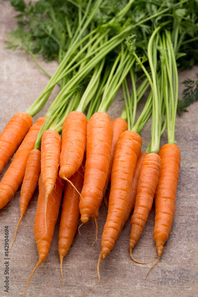 Fresh and sweet carrot on a grey wooden table. Fresh and sweet carrot on a grey wooden table.