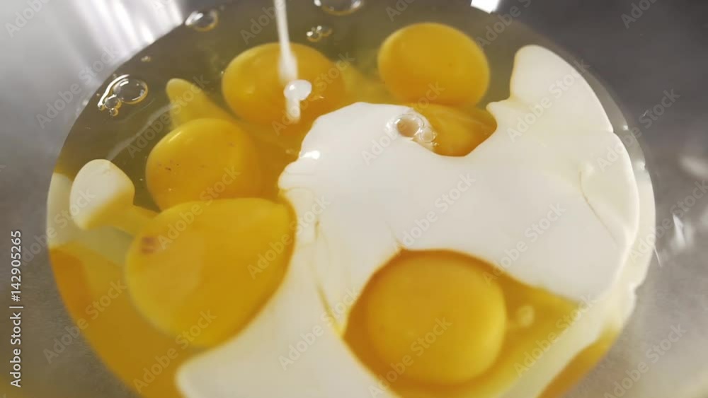 Chef makes omelet, raw eggs and cream, teasty breakfast, mom cooks breakfast at the kitchen Chef makes omelet, raw eggs and cream, teasty breakfast, mom cooks breakfast at the kitchen