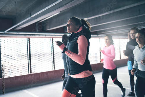 Attractive athletic woman urban running