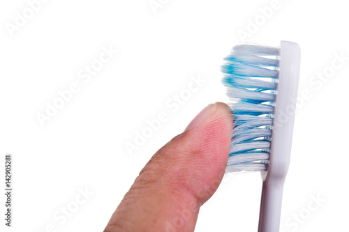 Φωτογραφία Finger touching soft and slim tapered toothbrush bristle