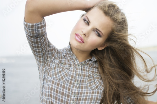 Portrait of young beautiful woman close-up on a walk in the city