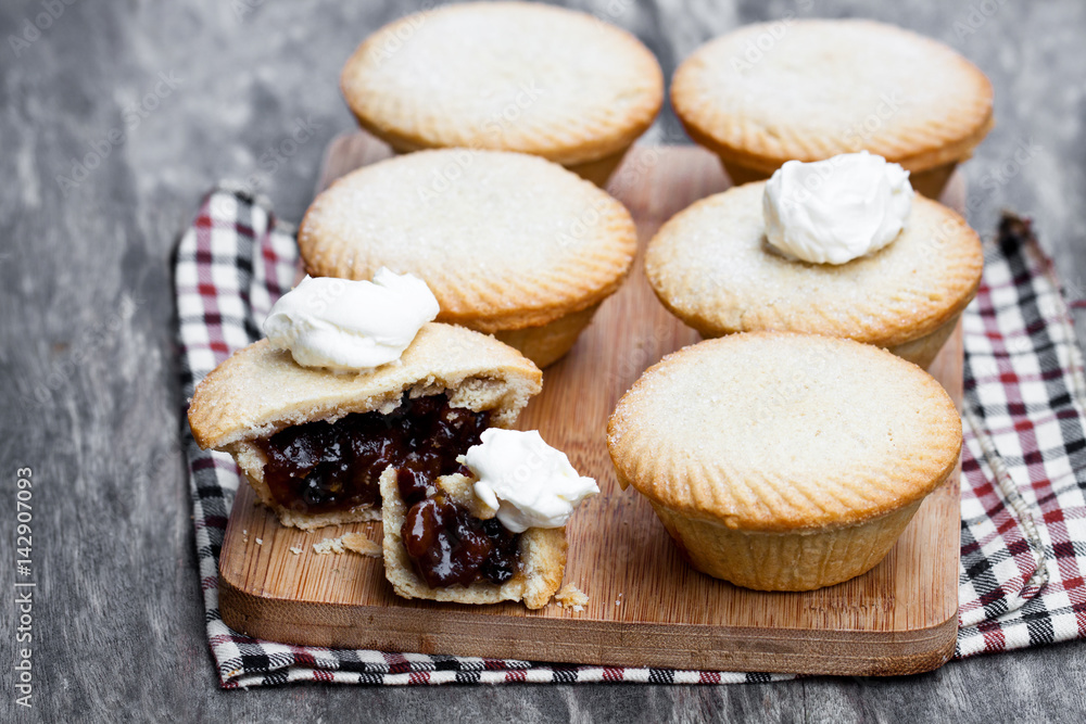 Mince pie group on cutting board on wooden background Mince pie group on cutting board on wooden background