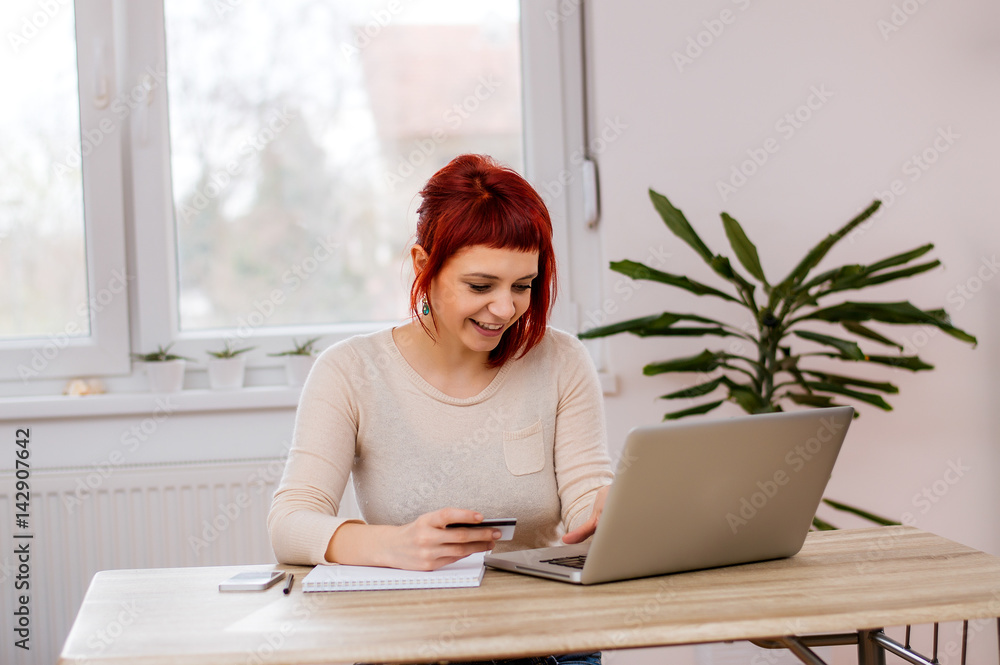 Smiling businesswoman with laptop and credit card Smiling businesswoman with laptop and credit card