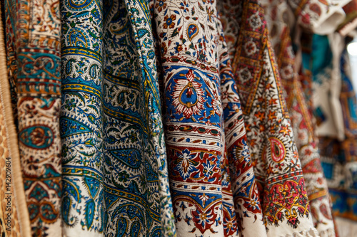 Many colorful carpets for sale on a street