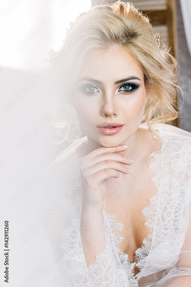 Portrait of a beautiful girl in a negligee with beautiful hair and makeup Portrait of a beautiful girl in a negligee with beautiful hair and makeup