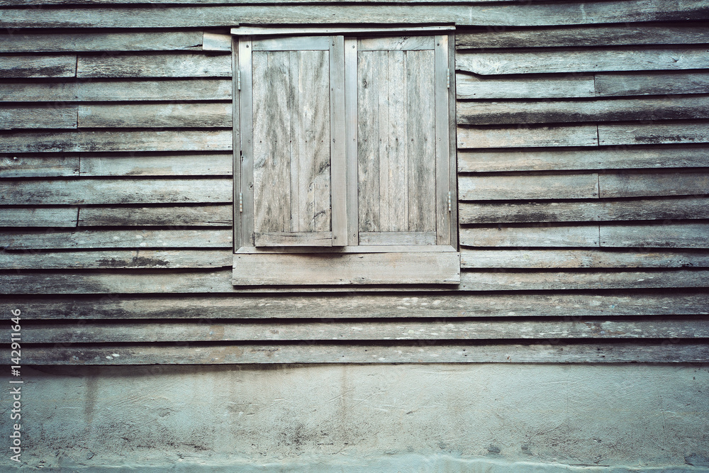 Old wooden window on a wooden wall texture background Old wooden window on a wooden wall texture background