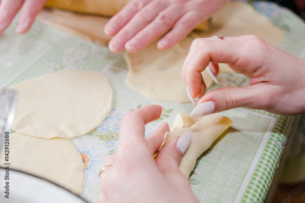 The woman molds manti. Cooking of the house, home-made food, food. The woman molds manti. Cooking of the house, home-made food, food.