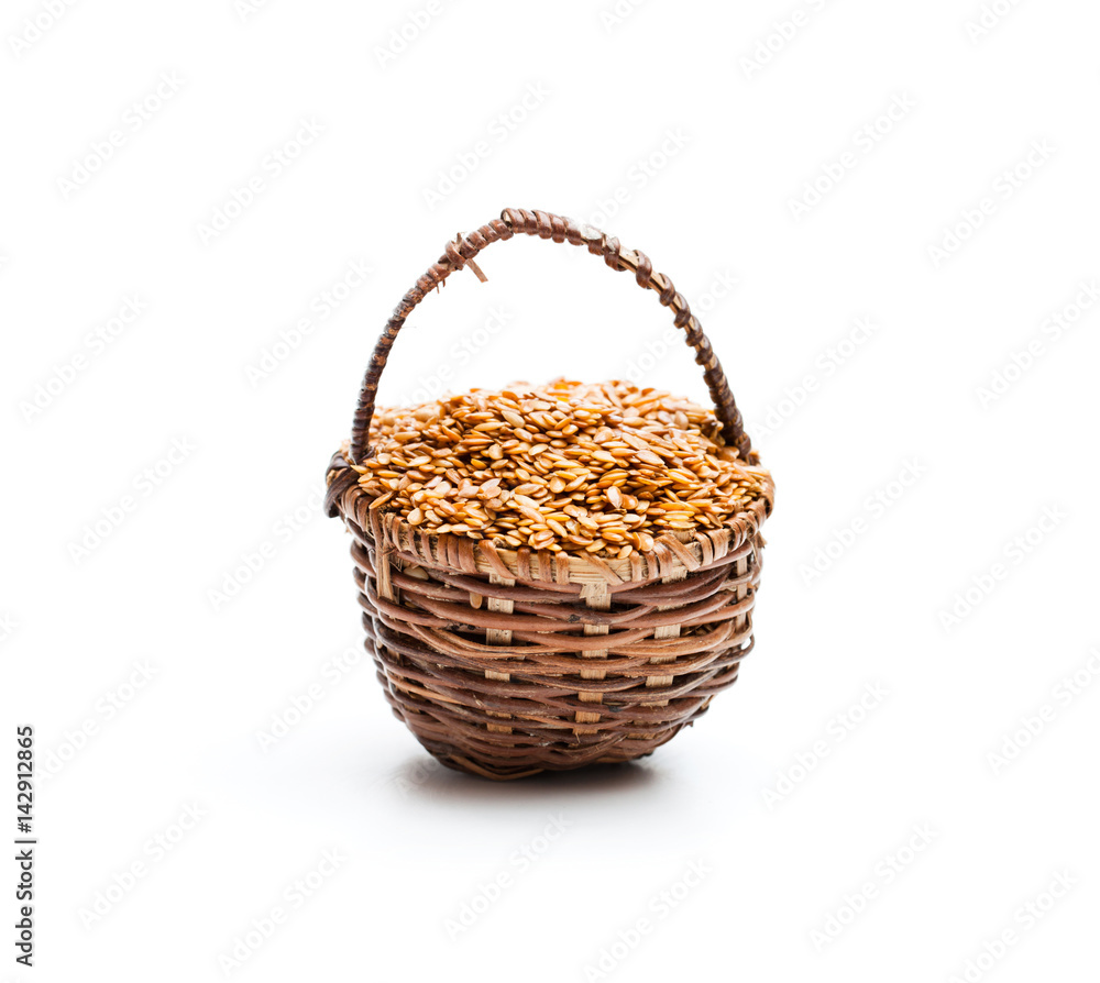 Flax seeds in small basket on white background Flax seeds in small basket on white background