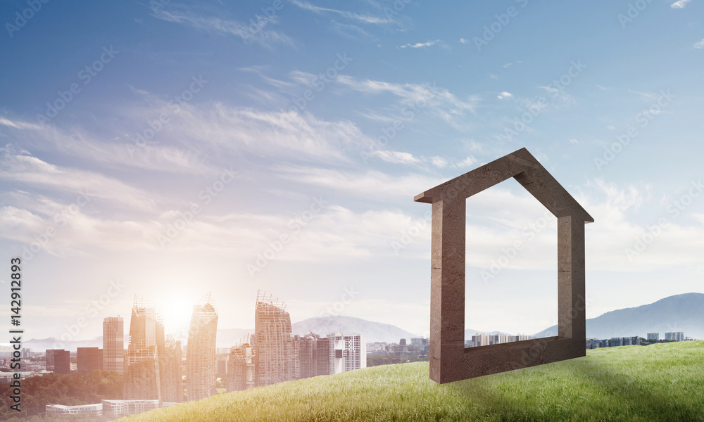 Conceptual image of concrete home sign on hill and natural landscape at background Conceptual image of concrete home sign on hill and natural landscape at background