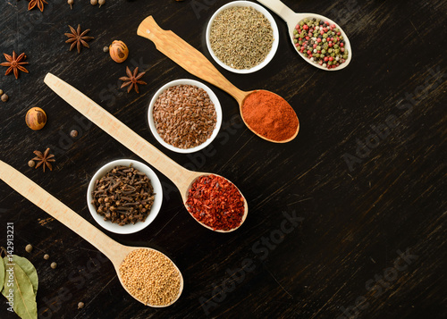 Fototapeta Naklejka Na Ścianę i Meble -  Various spices on wooden spoons. Food ingredients