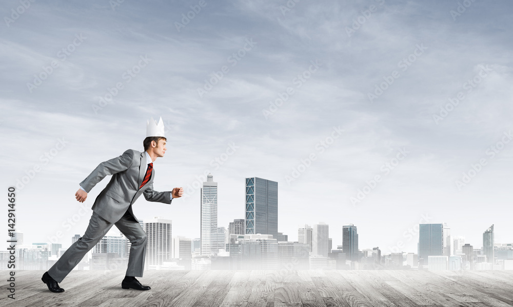 King businessman in elegant suit running and modern cityscape at background King businessman in elegant suit running and modern cityscape at background