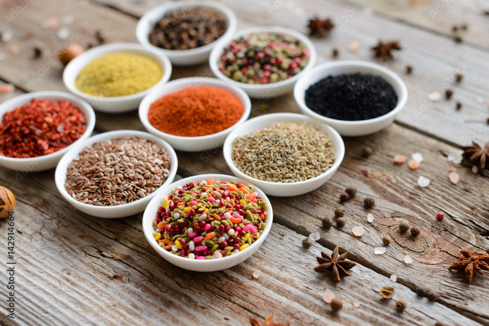 Various spices on wooden spoons. Food ingredients