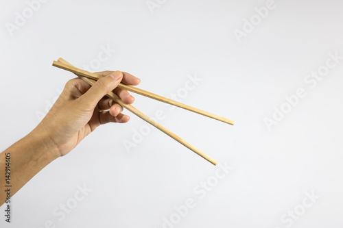 Hand gripping chopsticks