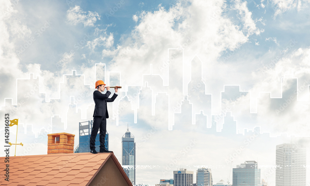 Engineer man standing on roof and looking in spyglass. Mixed med Engineer man standing on roof and looking in spyglass. Mixed med