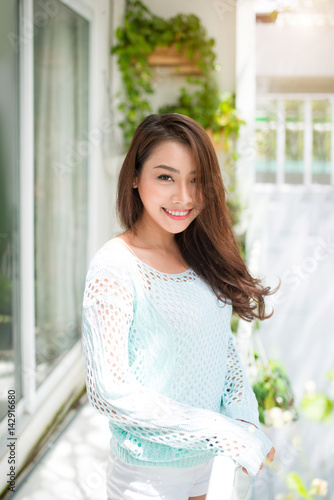 Free Download Asian woman enjoying fresh air at home - GFXLoad