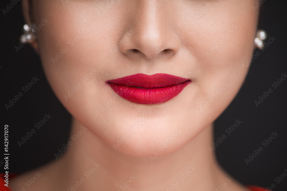 Beauty. Close up view of beautiful woman lips with red matt lipstick Beauty. Close up view of beautiful woman lips with red matt lipstick