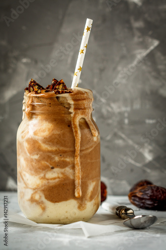 Fotografie Chocolate smoothie in glass jar with a banana, dates and sweets