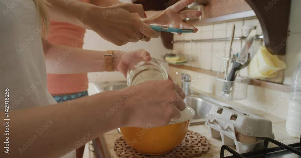Close up woman hand beating egg Friends making home made Pancakes taking photo using phone sharing on social media Close up woman hand beating egg Friends making home made Pancakes taking photo using phone sharing on social media