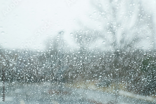 rain drop on window glass and outside trees