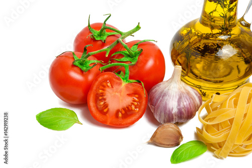 Fresh tomatoes, garlic, pasta and olive oil isolated on white background