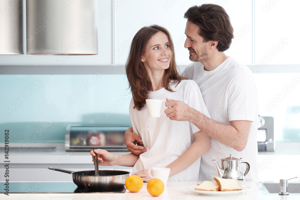 Couple cooking breakfast Couple cooking breakfast