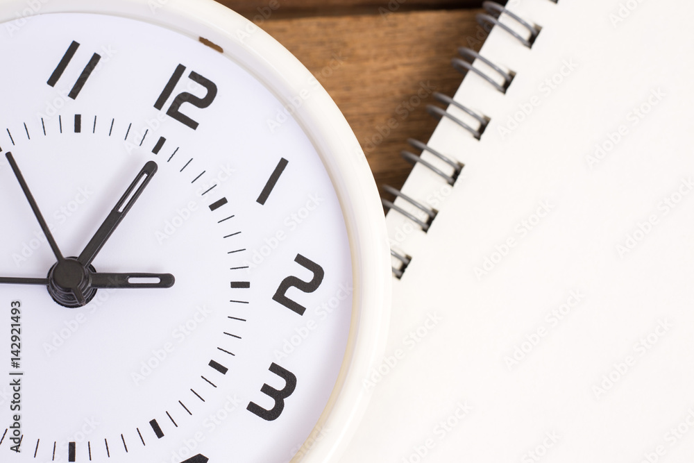 Close up white clock on wood texture background Close up white clock on wood texture background
