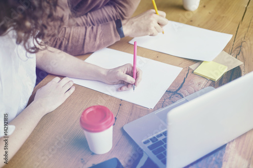 Two young professionals or students woman man happy with business meeting, smiling and talking about project. Office blue wall background