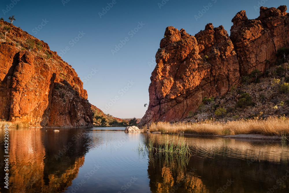 Reflections of rock formations at Glen Helen Gorge water hole
