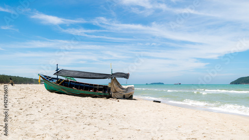 Old wooden fishing boat parked on the beach. © kaipungyai
