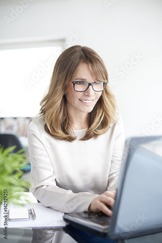 Professional woman at office. Shot of an attractive mature businesswoman working in her workstation.
