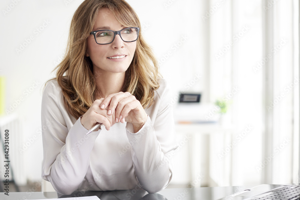 Confident professional woman portrait. Shot of an attractive mature businesswoman working on laptop at office Confident professional woman portrait. Shot of an attractive mature businesswoman working on laptop at office