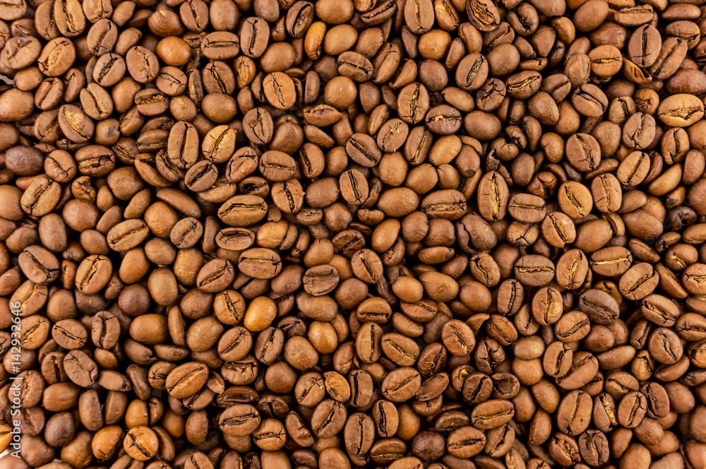 Juicy, fragrant, not ground coffee beans. Background of coffee beans with a saturated coffee color. Juicy, fragrant, not ground coffee beans. Background of coffee beans with a saturated coffee color.