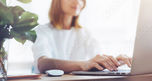Attractive female typing messages on a laptop, Attractive business woman analyzing sales of month on her laptop at office