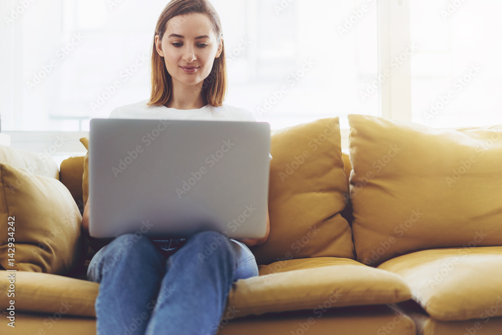 Self employed woman working on a new project from home, Smiling female freelancer using modern laptop and creating new project Self employed woman working on a new project from home, Smiling female freelancer using modern laptop and creating new project