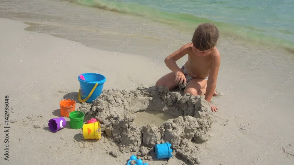 Little Girl Building Sand Castle on Beach Little Girl Building Sand Castle on Beach