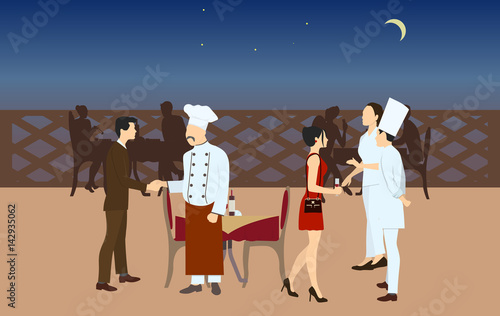Chefs meet with visitors to present their meals. Nght time restaurant.