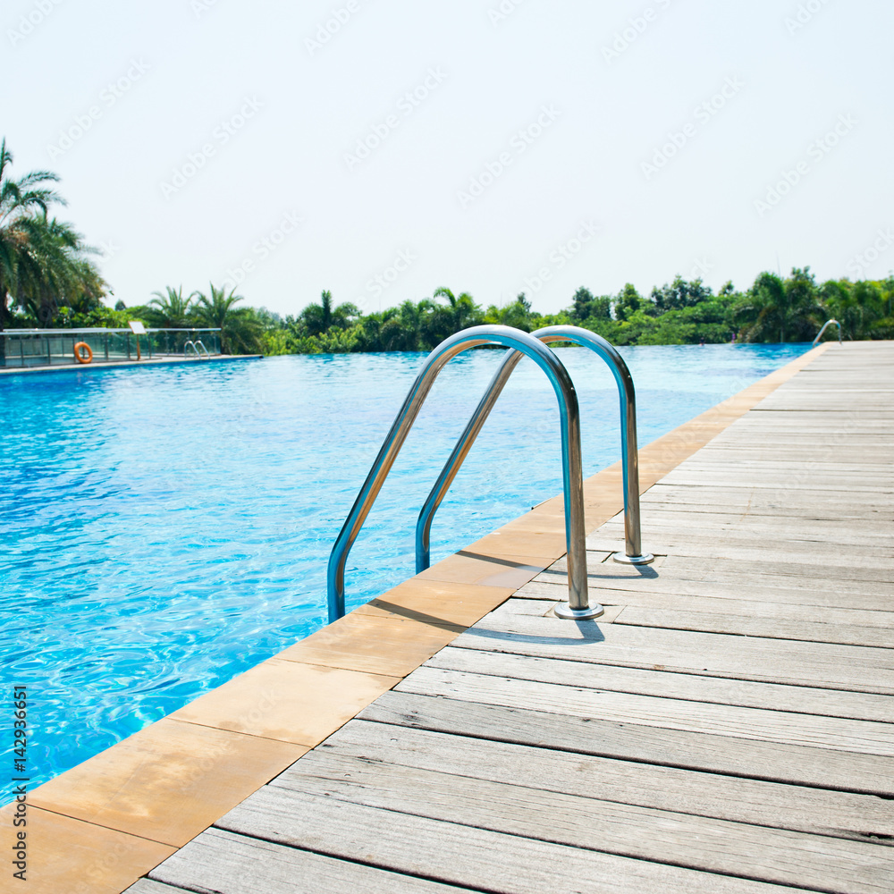 Swimming pool with stair and wooden deck at hotel. Swimming pool with stair and wooden deck at hotel.
