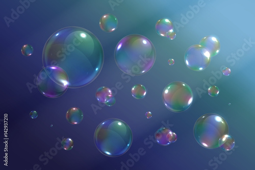 Vector set of isolated realistic soap bubbles on the blue background.