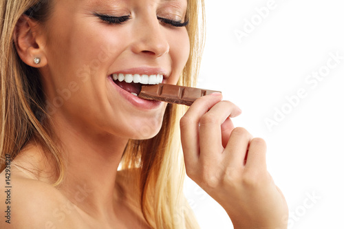 Portrait of beautiful woman holding chocolate bar