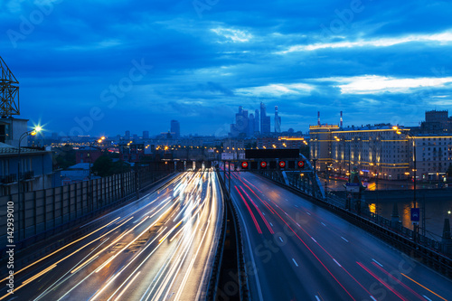 Movement of cars along the avenue in Moscow at dusk