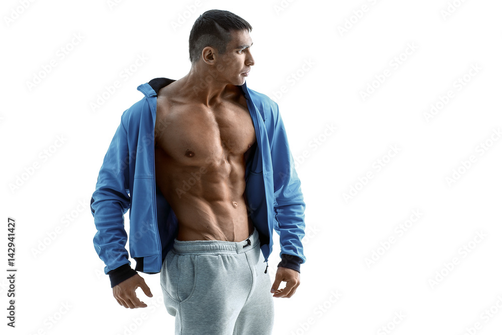 Fototapeta premium Middle aged man with a beautiful sports body posing on white background in sportswear. Dressed in a sporty jacket and sports pants