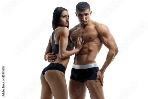 Young couple with a sports body posing on a white background
