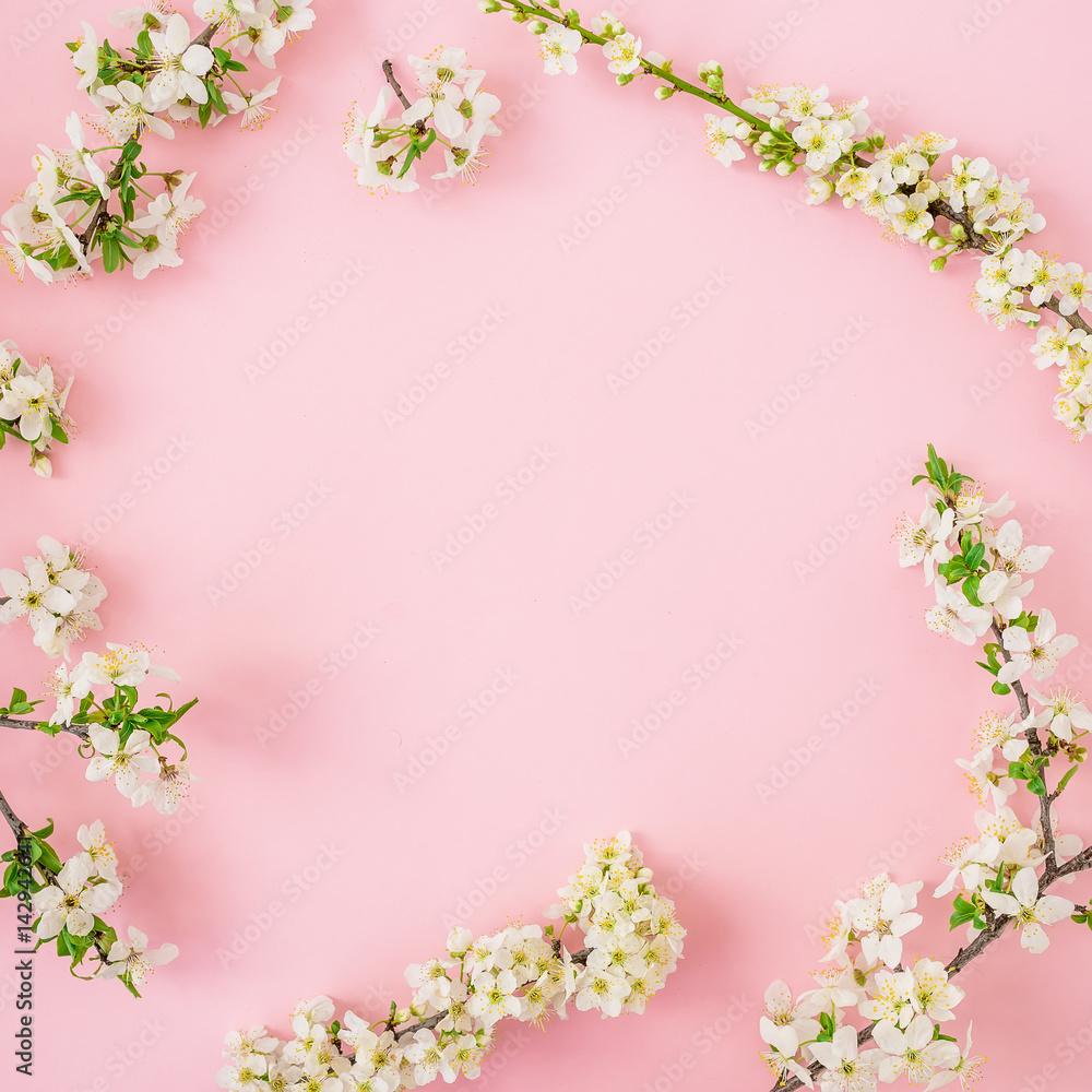 Floral frame of spring flowers on pink background. Flat lay, top view. Spring time background.